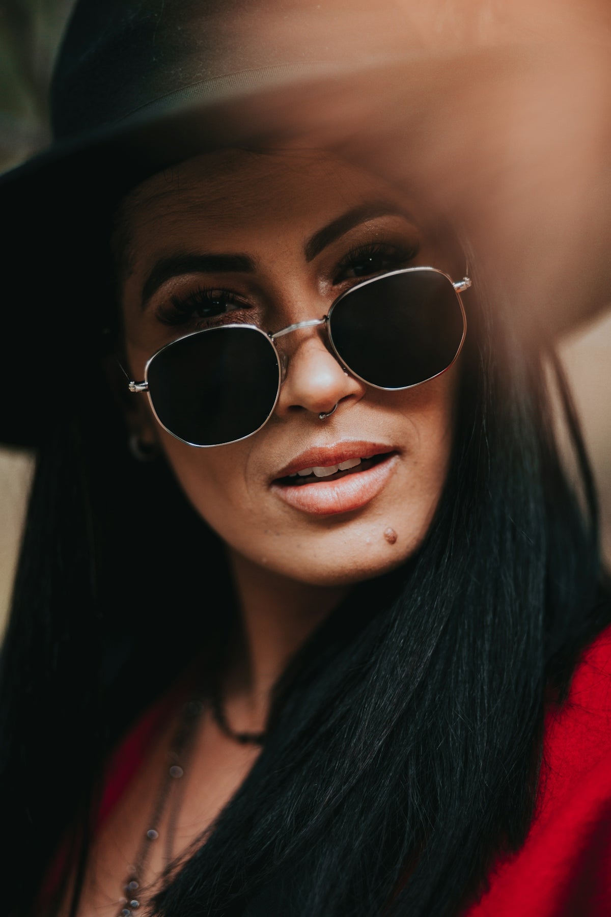 woman wearing gold framed aviator sunglasses